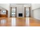 Open living room with soaring ceilings, fireplace, large windows with views and hardwood floors at 4800 E Cedar Ave, Denver, CO 80246
