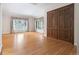 Inviting living room featuring hardwood floors, large windows, and elegant door at 4800 E Cedar Ave, Denver, CO 80246