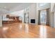 Bright, open living room featuring a fireplace, soaring ceilings, and adjacent kitchen at 4800 E Cedar Ave, Denver, CO 80246