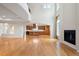 Grand open living space featuring wood floors, fireplace, kitchen and arched entryway at 4800 E Cedar Ave, Denver, CO 80246