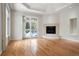 Living room with hardwood floors, fireplace and natural light from the sliding door at 4800 E Cedar Ave, Denver, CO 80246