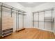 Walk-in closet featuring wood floors, shelving and built-in storage drawers at 4800 E Cedar Ave, Denver, CO 80246