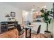 Dining area showcasing a glass table, wood floors, and an open view to the kitchen at 4100 Albion St # 611, Denver, CO 80216