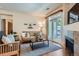 Cozy living room with a fireplace, sliding glass doors, and comfortable seating at 4100 Albion St # 611, Denver, CO 80216