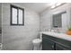 Bathroom with decorative tiles, a black vanity, and a window for natural light at 1061 S Yampa St # C, Aurora, CO 80017