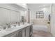 Well-lit bathroom featuring double sinks, a bathtub, and modern finishes at 1061 S Yampa St # C, Aurora, CO 80017
