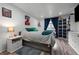 Bedroom with wood-look flooring, white walls, and unique comic-themed decor at 1061 S Yampa St # C, Aurora, CO 80017
