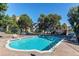 Sparkling community pool surrounded by lounge chairs and lush greenery at 1061 S Yampa St # C, Aurora, CO 80017