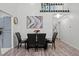 Bright dining room with modern table, black leather chairs, and an eye-catching art piece on the wall at 1061 S Yampa St # C, Aurora, CO 80017