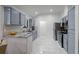 Updated kitchen features stainless steel appliances, tile backsplash, gray cabinets and marble countertops at 1061 S Yampa St # C, Aurora, CO 80017