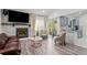 Stylish living room boasts a stone fireplace, hardwood floors, and ample natural light at 1061 S Yampa St # C, Aurora, CO 80017