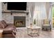 Cozy living room featuring a stone fireplace with wood burning fire and stylish decor at 1061 S Yampa St # C, Aurora, CO 80017