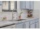 Close-up of the kitchen sink with a stainless steel faucet and mosaic backsplash at 1061 S Yampa St # C, Aurora, CO 80017
