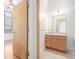 Bathroom with vanity and sink, with partial view of bedroom at 7700 E 29Th Ave # 405, Denver, CO 80238