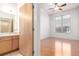 Bathroom and bedroom view with light wood cabinets, granite counters and modern lighting at 7700 E 29Th Ave # 405, Denver, CO 80238