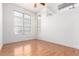 Spacious bright bedroom featuring large windows, hardwood floors, and neutral tones, creating a serene atmosphere at 7700 E 29Th Ave # 405, Denver, CO 80238