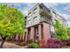 Contemporary condo building features private balconies, brick accents, and lush landscaping at 7700 E 29Th Ave # 405, Denver, CO 80238