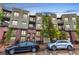 Modern condo complex with brick and siding, balconies, and convenient street parking at 7700 E 29Th Ave # 405, Denver, CO 80238