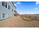 View of backyard with a rockscape design, lawn area, deck, and a classic wooden fence at 11926 Olive St, Thornton, CO 80233