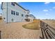 View of backyard with a rockscape design, lawn area, deck, and a classic wooden fence at 11926 Olive St, Thornton, CO 80233