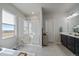 Bright bathroom with walk-in shower and large window at 11926 Olive St, Thornton, CO 80233