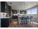 Open kitchen boasts stainless appliances, a center island with bar seating, and access to an outdoor deck at 11926 Olive St, Thornton, CO 80233