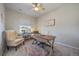 Bright home office featuring a comfortable chair, wooden desk, and natural light from a window at 11926 Olive St, Thornton, CO 80233