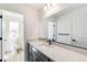 Bright bathroom with light wood floors, modern vanity and a large mirror at 4451 Soapberry Pl, Castle Rock, CO 80108