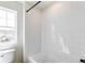 Bright bathroom features white tile shower and a window at 4451 Soapberry Pl, Castle Rock, CO 80108