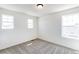 Bright bedroom with gray carpet, white walls, and lots of natural light from large windows at 4451 Soapberry Pl, Castle Rock, CO 80108