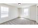 Bright bedroom with gray carpet, white walls, and lots of natural light from large windows at 4451 Soapberry Pl, Castle Rock, CO 80108