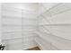 Walk-in closet features ample storage with wire shelving and wood-look floors at 4451 Soapberry Pl, Castle Rock, CO 80108