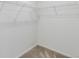 Walk-in closet with installed shelving and plush gray carpeting at 4451 Soapberry Pl, Castle Rock, CO 80108
