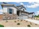 Charming two-story home featuring stone accents, gray siding and a two-car garage at 4451 Soapberry Pl, Castle Rock, CO 80108
