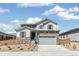Charming two-story home featuring stone accents, gray siding and a two-car garage at 4451 Soapberry Pl, Castle Rock, CO 80108