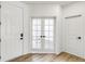 Bright foyer with hardwood floors, a white front door, and double French doors at 4451 Soapberry Pl, Castle Rock, CO 80108