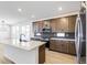 Open kitchen featuring a large center island, stainless steel appliances, and a modern design at 4451 Soapberry Pl, Castle Rock, CO 80108
