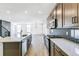 Spacious open kitchen with stainless appliances, white counters and view to the living room at 4451 Soapberry Pl, Castle Rock, CO 80108
