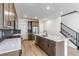 Contemporary kitchen with stainless steel appliances, center island, and access to staircase at 4451 Soapberry Pl, Castle Rock, CO 80108