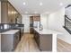 Modern kitchen with stainless steel appliances, center island, and stylish backsplash at 4451 Soapberry Pl, Castle Rock, CO 80108