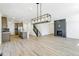 Open-concept living room with hardwood floors, modern lighting, and a fireplace at 4451 Soapberry Pl, Castle Rock, CO 80108