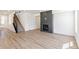 Open living room features hardwood floors, a modern fireplace and stairs at 4451 Soapberry Pl, Castle Rock, CO 80108