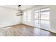 Bright living space with a modern light fixture and sliding door access to the balcony at 4451 Soapberry Pl, Castle Rock, CO 80108