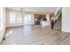 Spacious living room featuring hardwood floors, stairs, and stainless kitchen appliances at 4451 Soapberry Pl, Castle Rock, CO 80108