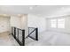 Bright loft area with modern railing, plush gray carpeting, and natural light from double windows at 4451 Soapberry Pl, Castle Rock, CO 80108