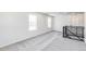 Bright loft with gray carpet, white walls, and lots of natural light from large windows at 4451 Soapberry Pl, Castle Rock, CO 80108
