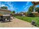 Spacious backyard features a well-maintained lawn and a patio with a Traeger grill, ideal for outdoor entertaining at 7101 Alan Dr, Denver, CO 80221