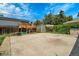 Backyard features a concrete patio with a basketball hoop, shed, and a wooden fence with green foliage at 7101 Alan Dr, Denver, CO 80221