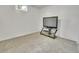 A carpeted basement area with a television on a glass stand at 7101 Alan Dr, Denver, CO 80221