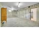 Large finished basement with white-washed walls, grey carpet, and vintage wooden dresser at 7101 Alan Dr, Denver, CO 80221